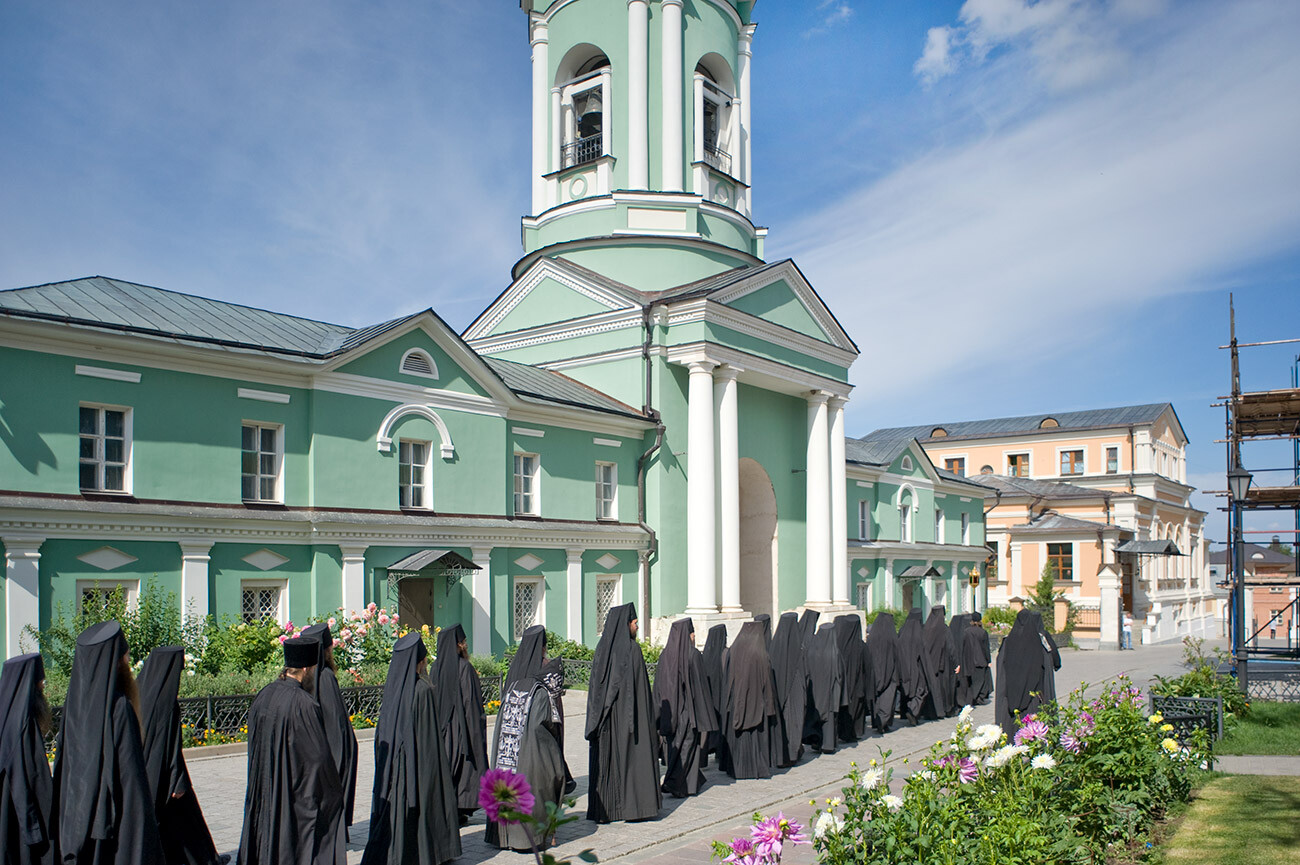 Optina Pustyn, Monastery of the Presentation. Monastery bell tower flanked by south & north cloisters. Sunday procession of monks to Refectory (on right). August 23, 2014