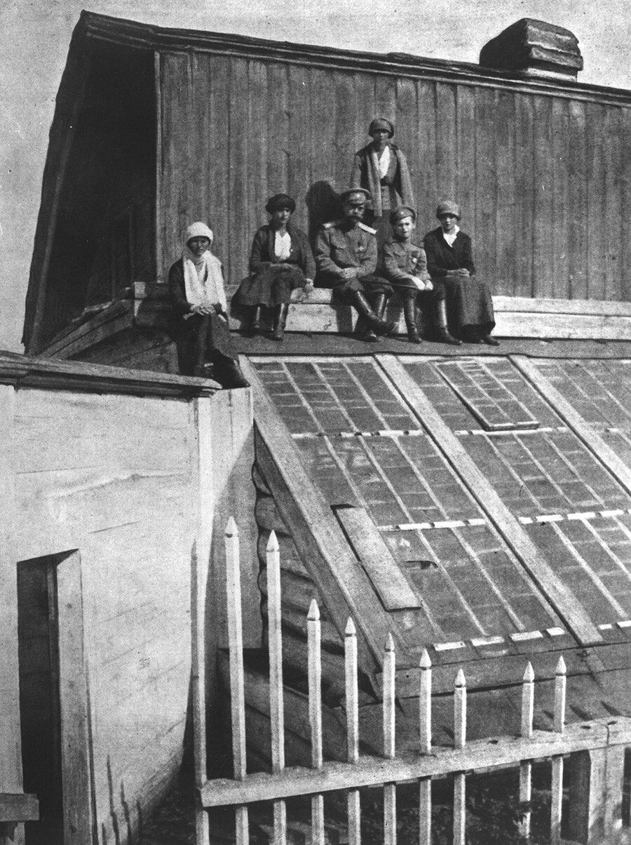 Nicholas with kids sitting on the roof of a greenhouse during their captivity In Tobolsk, 1918
