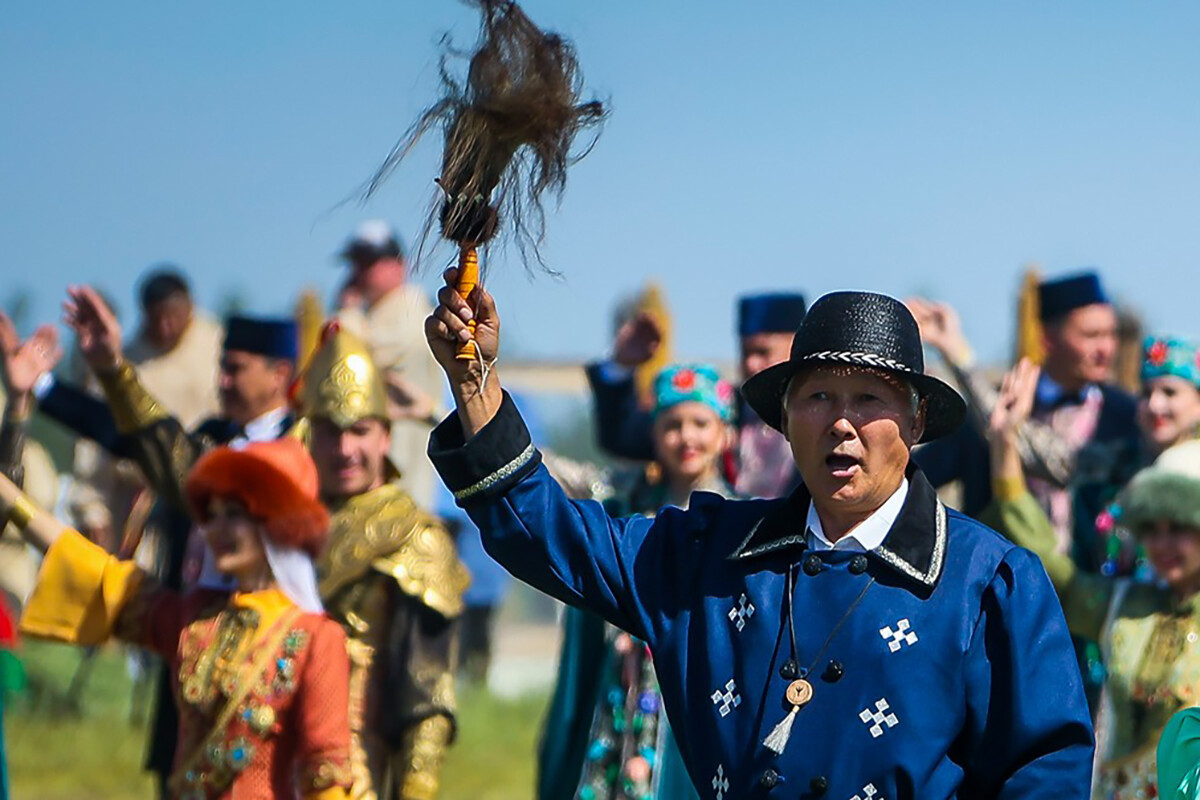 A man with a wooden horsehair tassel.