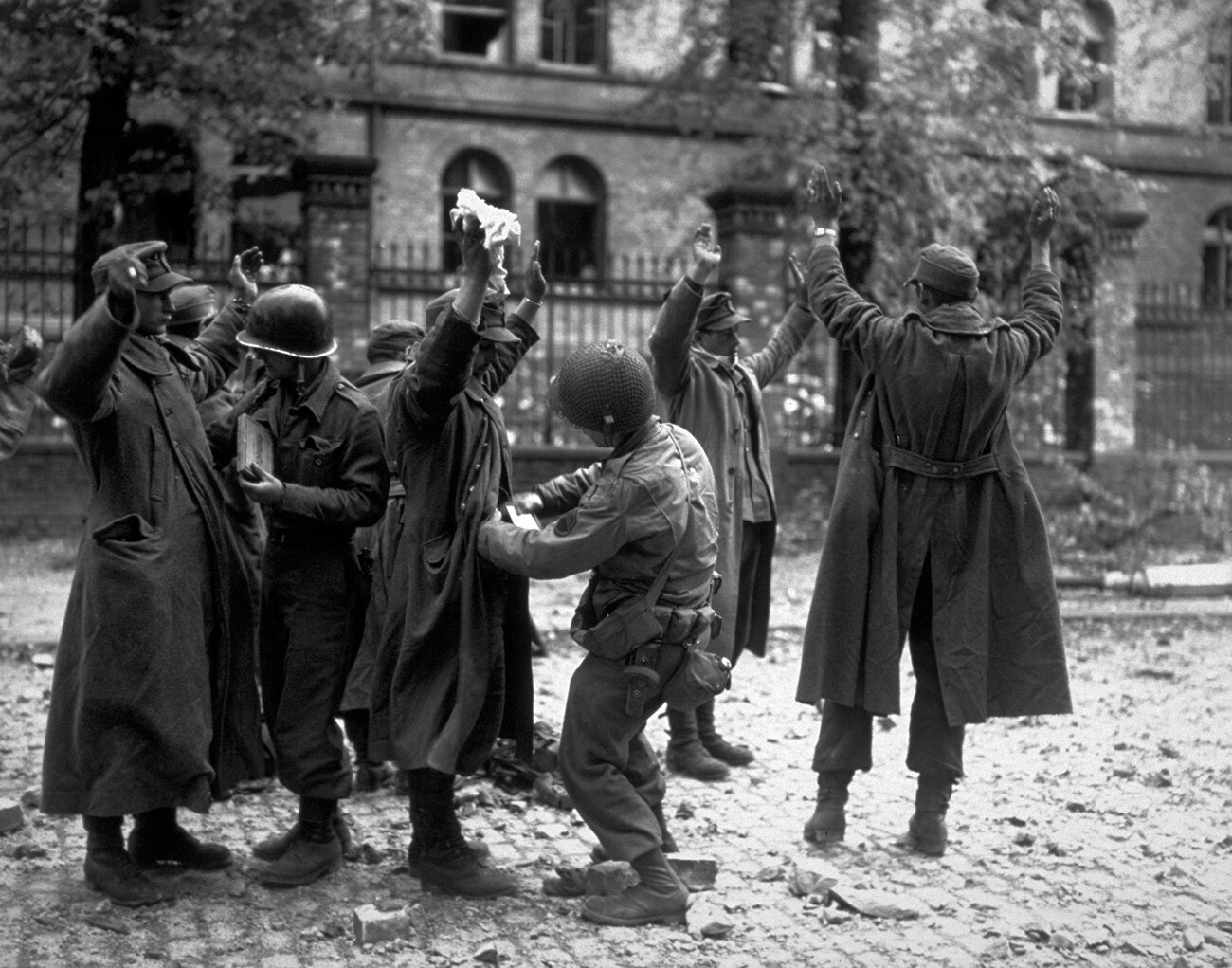 German prisoners captured by the American soldiers in the streets of Aachen. 