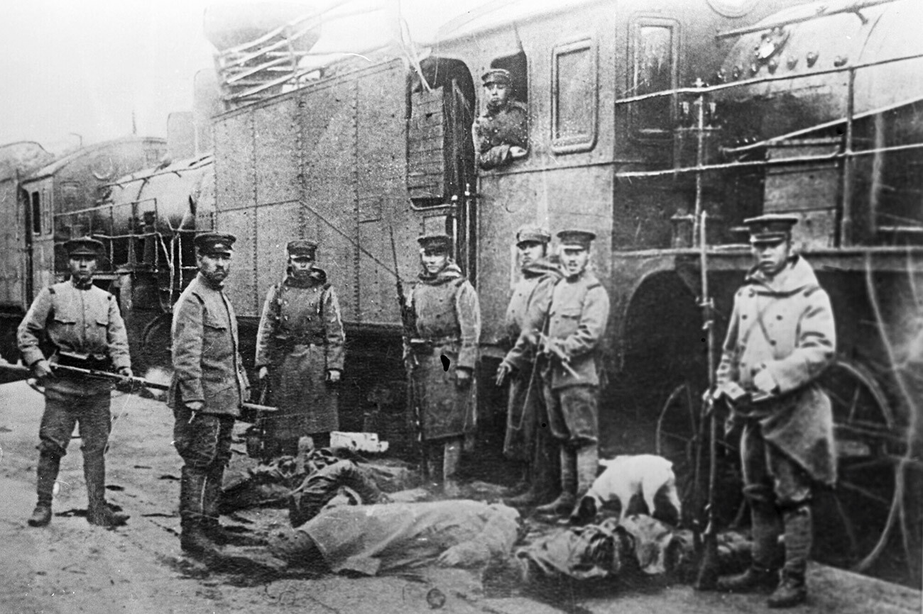 Japanese interventionists standing behind bodies of railway workers executed by them, Russian Far East, 1920.