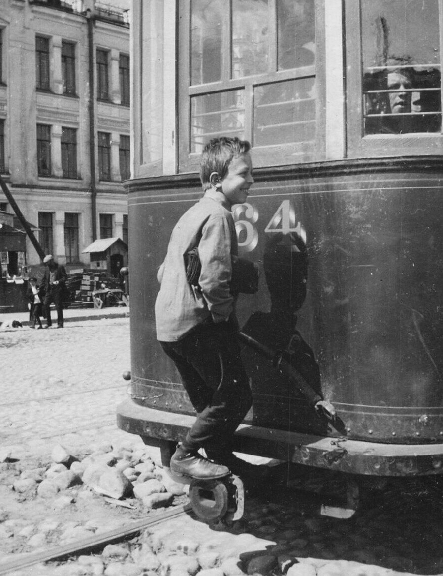 Il tipico modo di spostarsi dei bambini di strada e degli sbandati era attaccandosi al tram. Leningrado, 1928