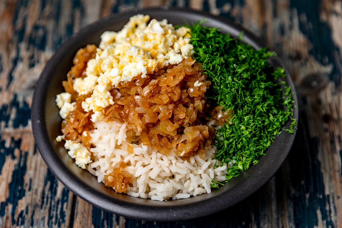 A piece of kurnik pie with chicken, potatoes and rice on a plate. Homemade  pastries Stock Photo by Aleruana