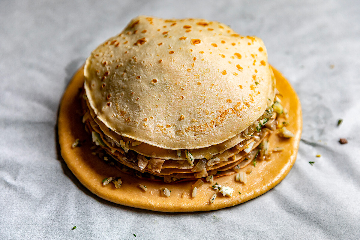 Traditional Russian pancakes pie - kurnik. Stock Photo