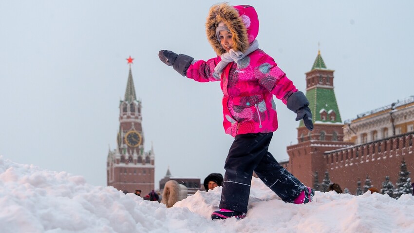 Moscow. Snowfall consequences in the city. Children play in a snowdrift in Red Square.