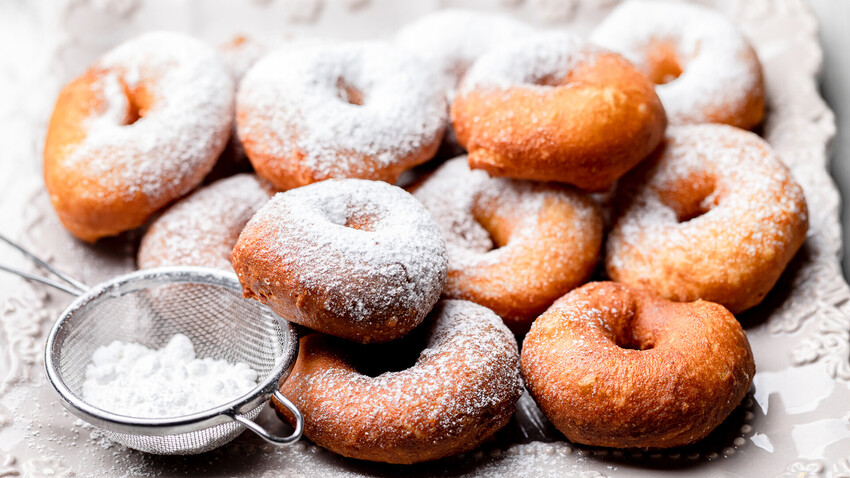 If you want to treat yourself to something sweet and buttery, try Russian “pyshki”.