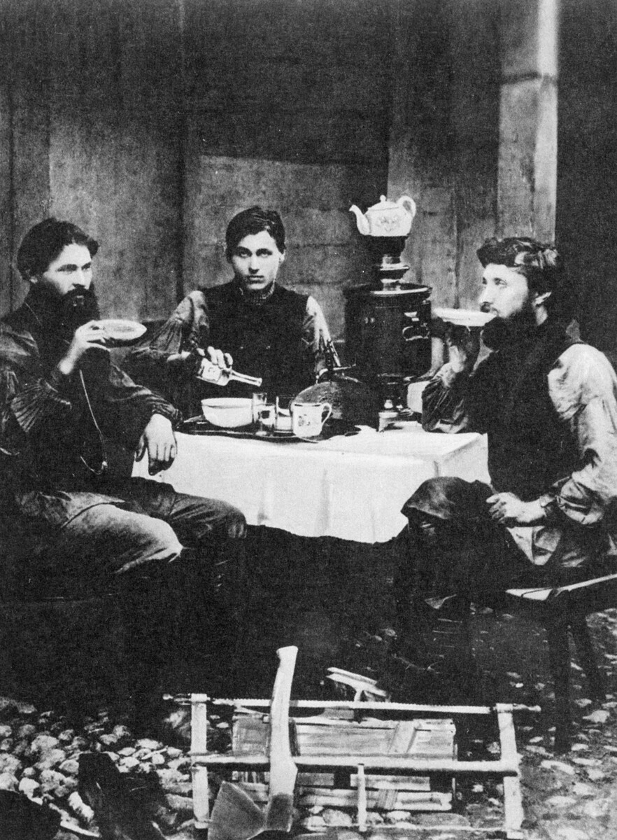 Three men sitting at a pub, 1870s.