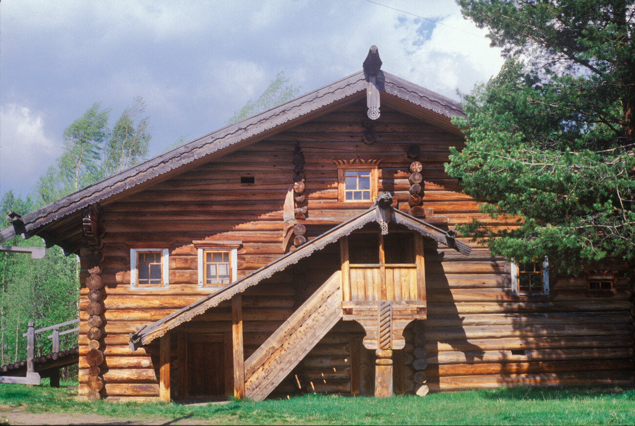 Shchegolev house, from Irta village, Lensky District.  Front view with elevated porch. Fine example of carved end boards. June 9, 1998