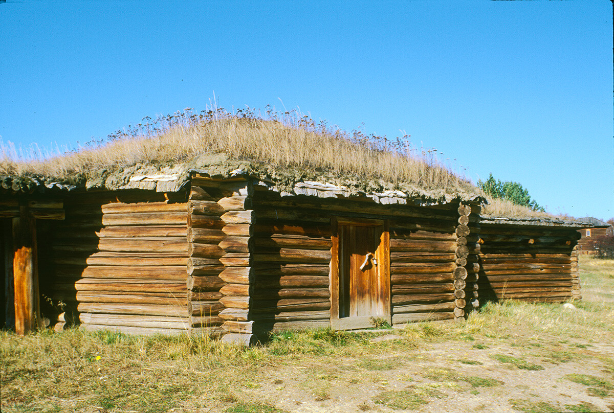Taltsy. Buriat log dwelling (yurt) with sod roof (Angara region). October 2, 1999