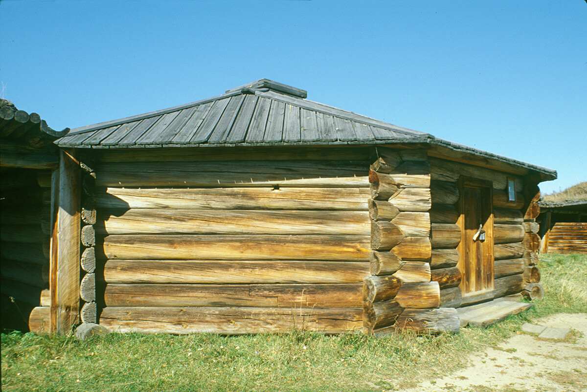 Taltsy. Buriat log dwelling (yurt) with wooden plank roof. October 2, 1999