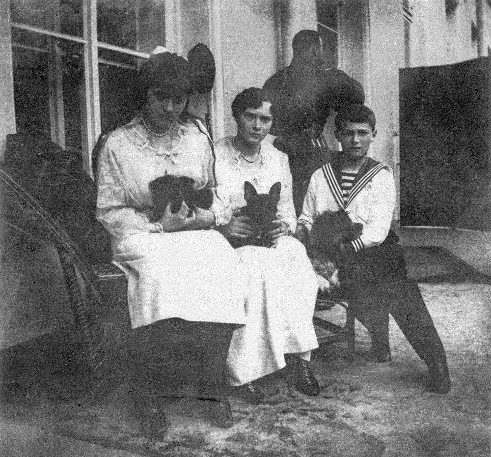The royal children and their dogs, left to right: Grand Duchess Anastasia and Jammie, Grand Duchess Tatiana and Ortipo, Tsarevich Alexei and Joy.