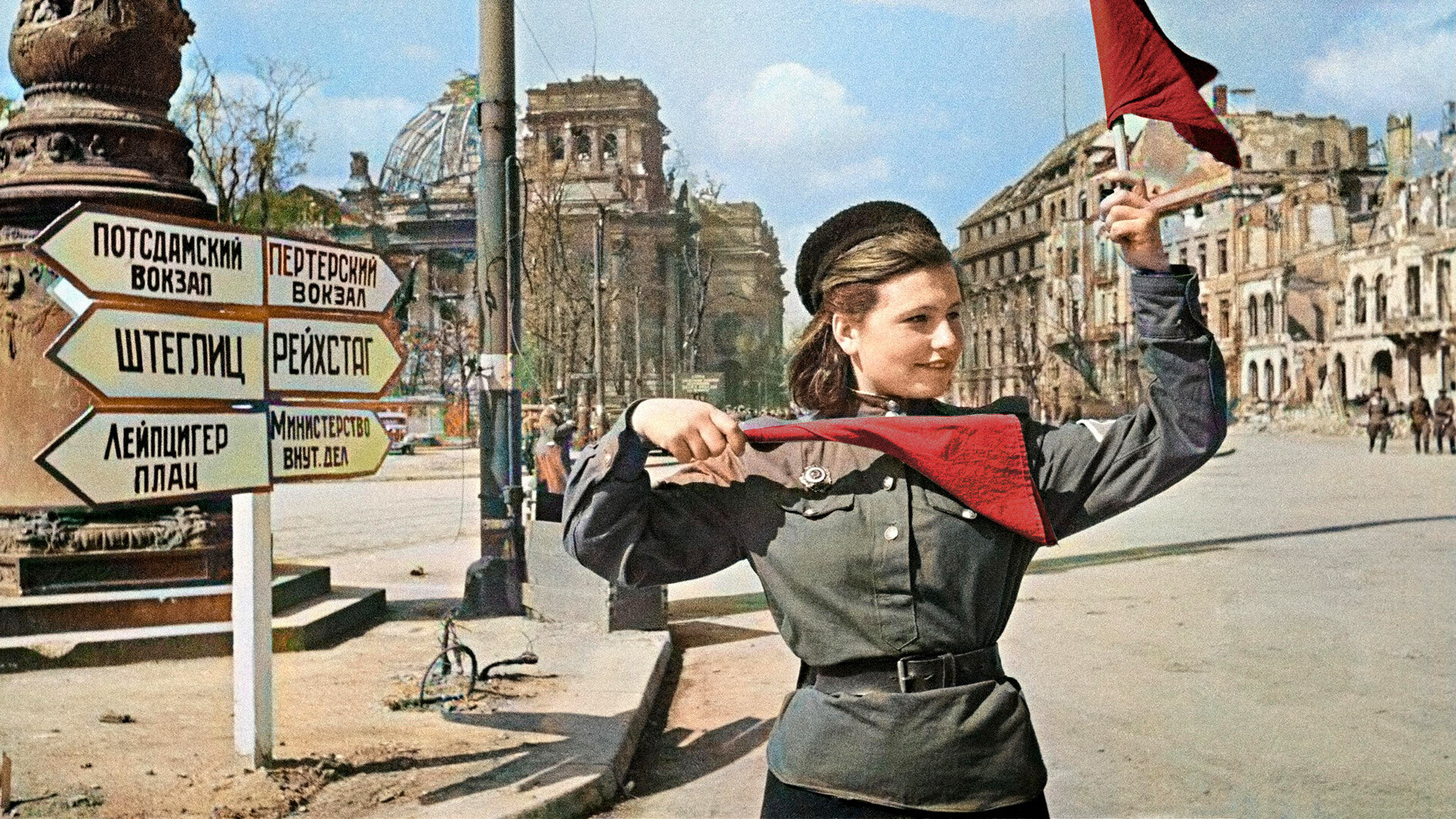 Red Army soldier Katya Spivak handling the traffgic in the streets of Berlin, May 1945.