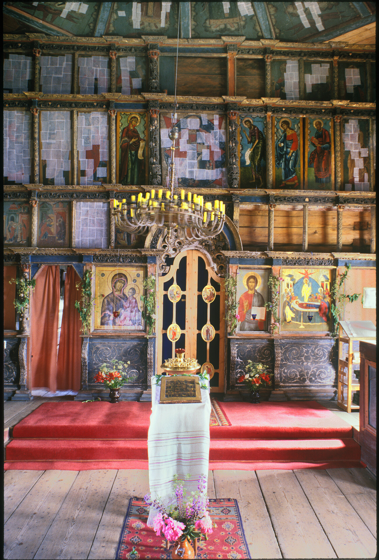 Church of the Dormition. View east toward icon screen. Icons partially covered with tissue squares during restoration. July 4, 2000