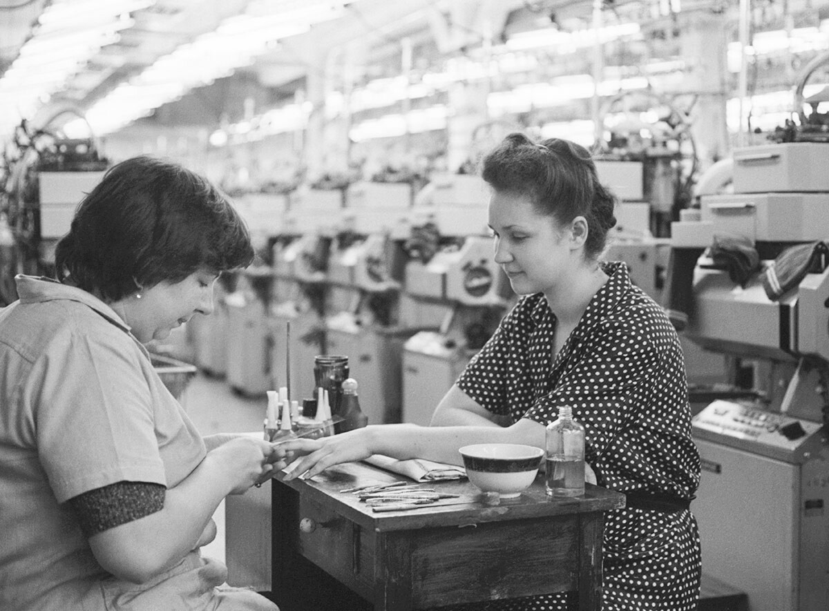 A Chief director of the plant Tamara Ivanyuk manicures the knitter Marina Tyurina. 1987. 