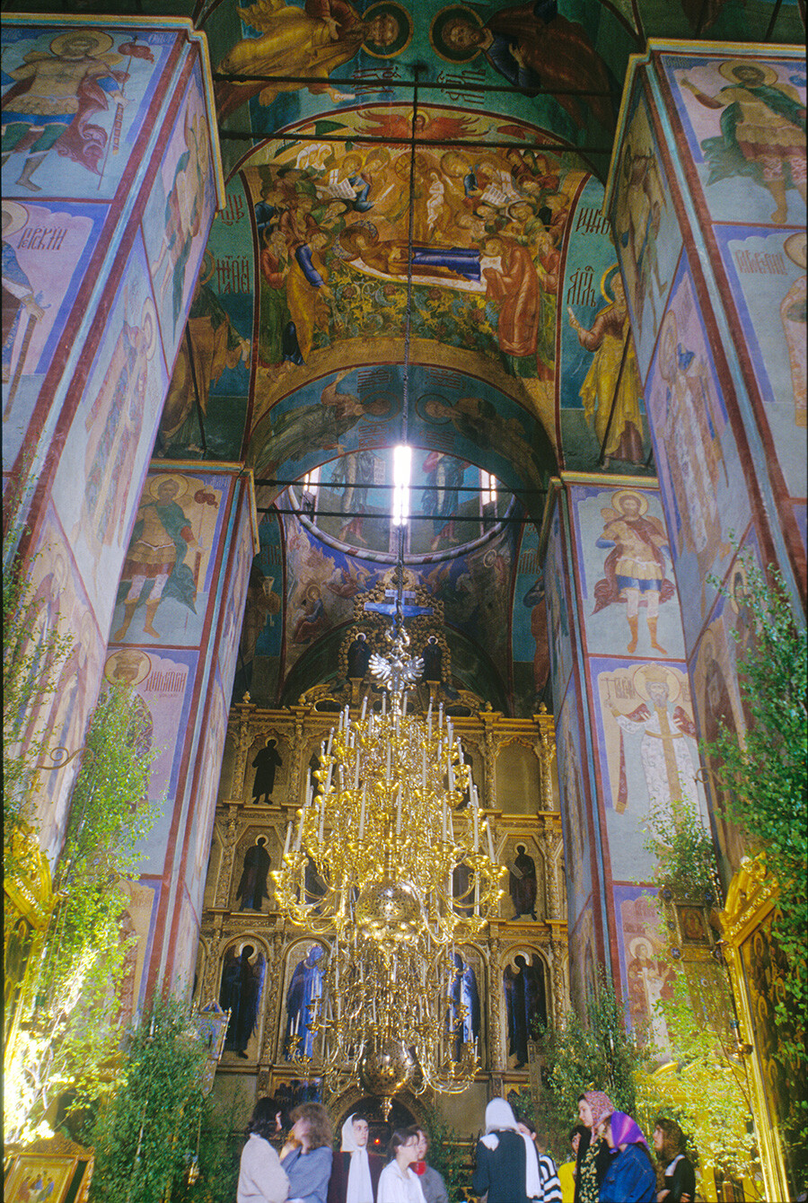 Trinity-St. Sergius Monastery. Dormition Cathedral. Central aisle with candelabra, view east toward icon screen & central dome. Fresco of Dormition of Mary on ceiling vault. May 29, 1999
