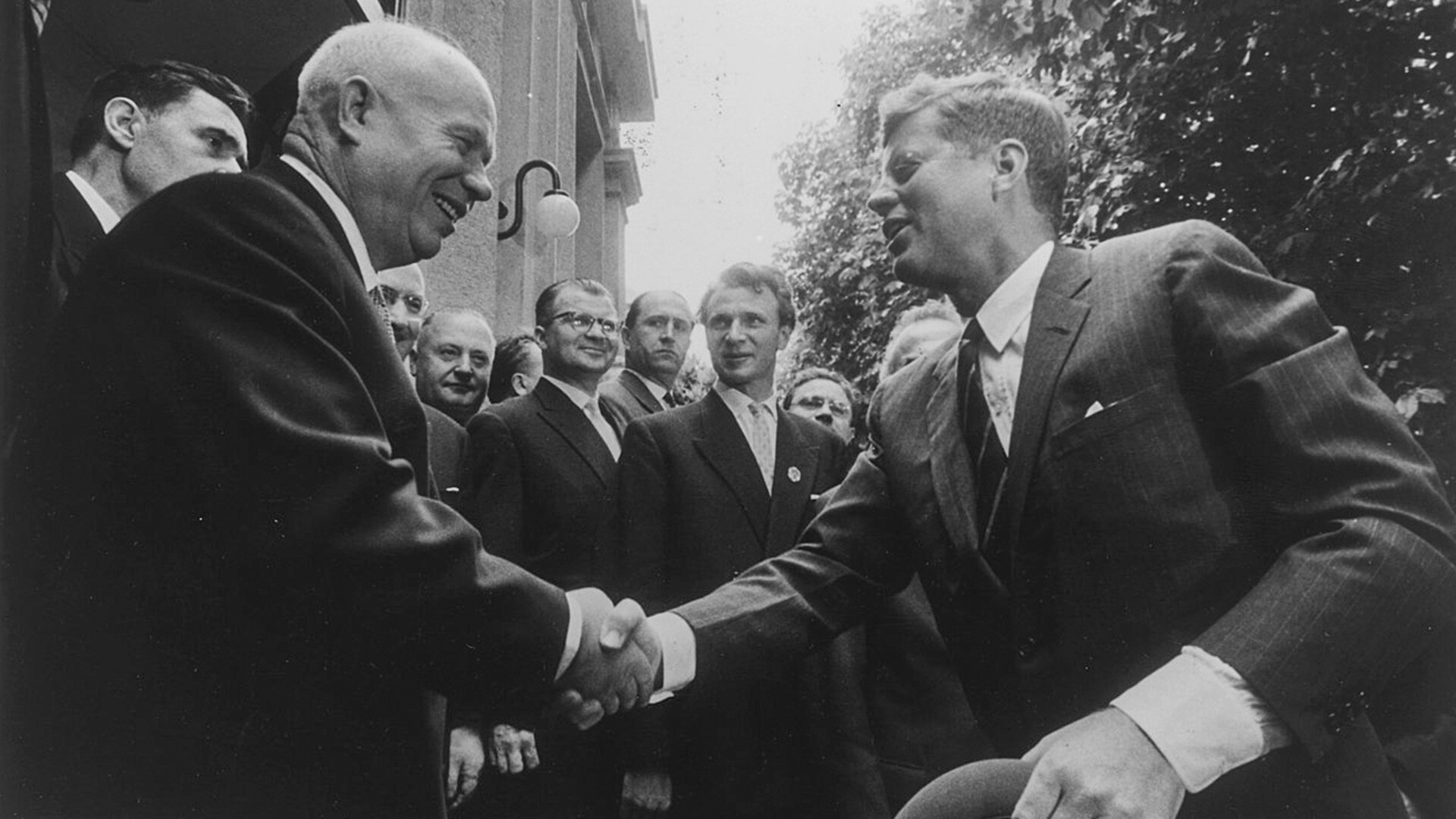 John F. Kennedy shaking hands with Nikita Khrushchev. 