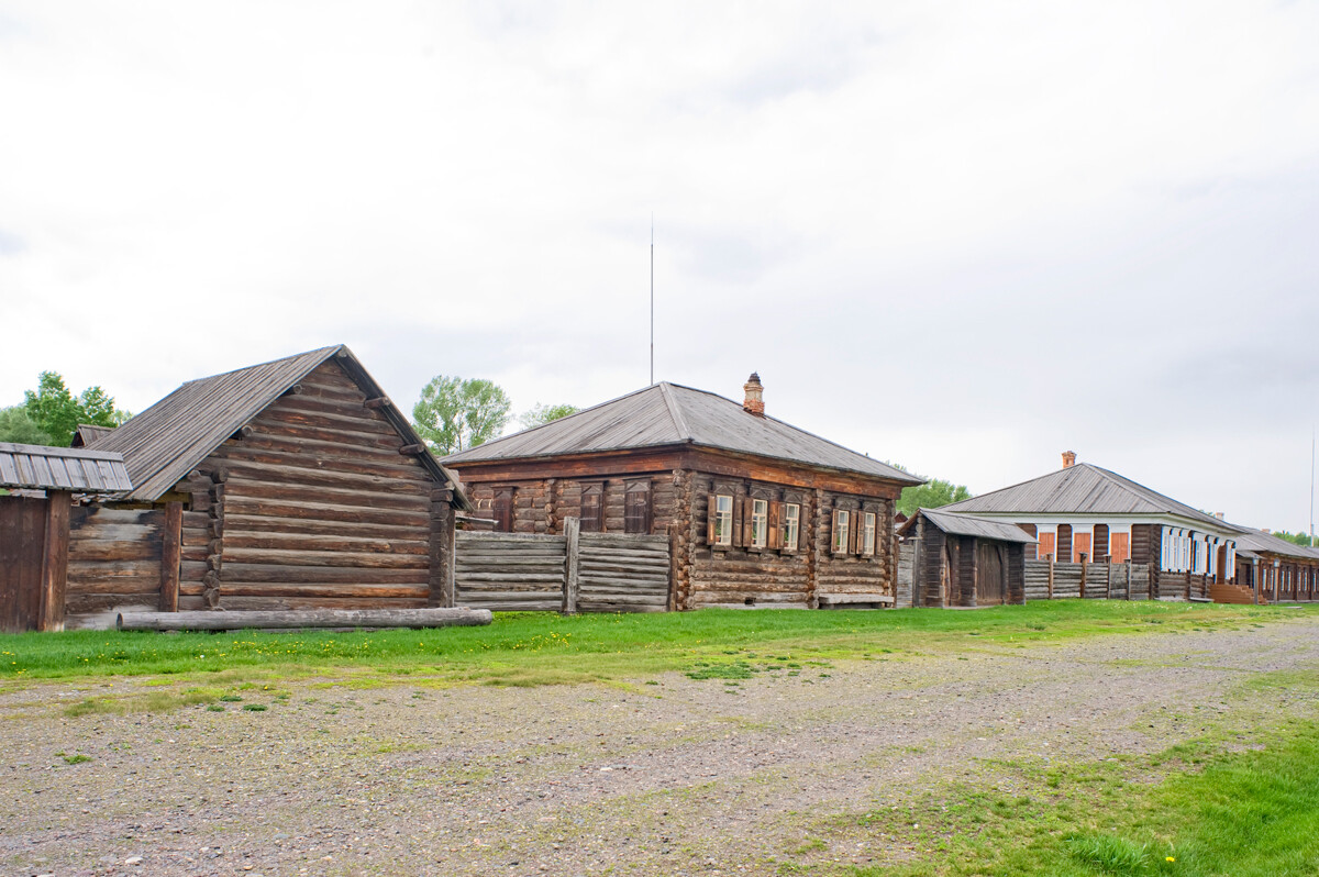 Shushenskoe Preserve.  Main street, K. Cherkashin household with barn, izba, & gate. Far right: Ernst Urban house & store. May 26, 2015