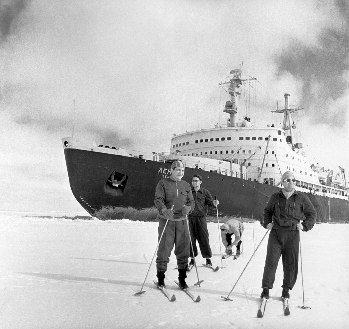 The crew of the first nuclear-powered icebreaker, ‘Lenin’ skiing in front of it, 1960.