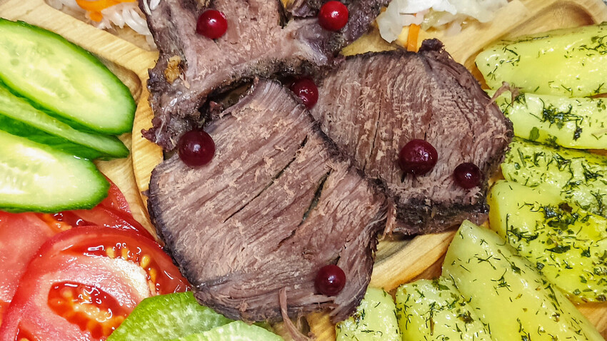 Savor the wild: Moose meat magic with lingonberry glaze and golden potatoes.