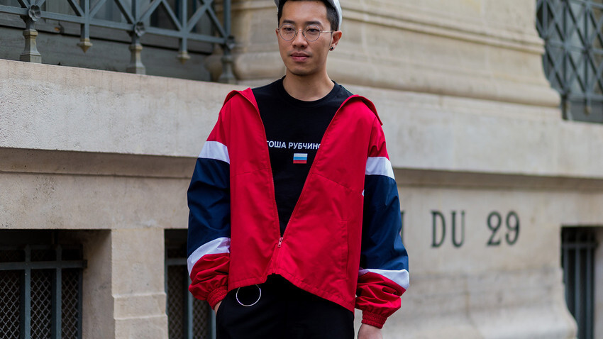 A guest wearing Gosha Rubchinskiy shirt and a red jacket outside Maison Margiela during the Paris Fashion Week Menswear Spring/Summer 2017.
