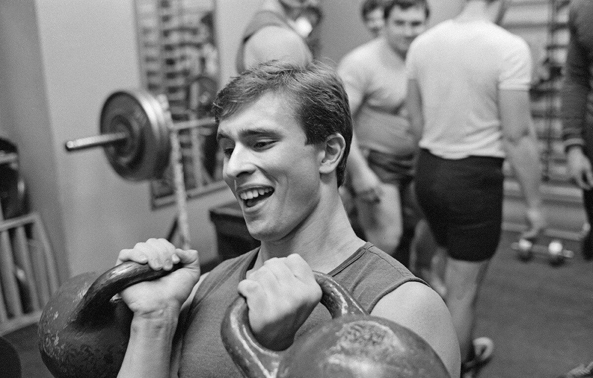 A young man training in a Soviet gym, 1980s