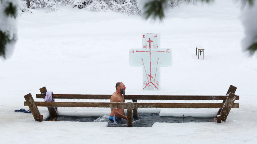 A man bathes in an ice hole on Epiphany, Russia