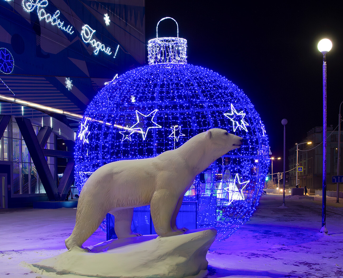 A sports complex in Norilsk and the monument to Aika next to it. 