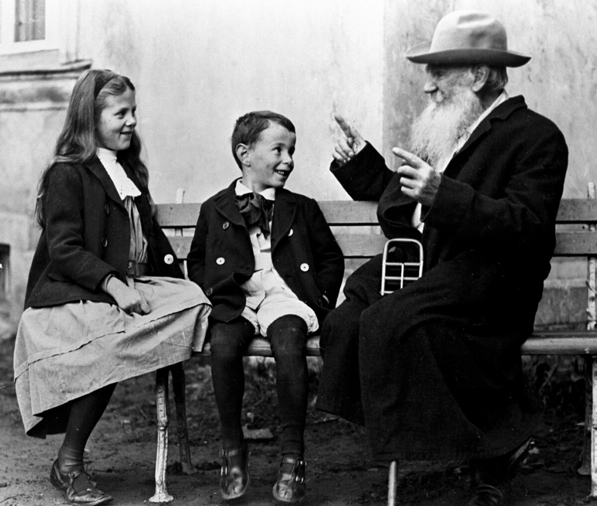Tolstoy tells a tale to his grandchildren Sophia and Ilya (Andrei's children), 1909 