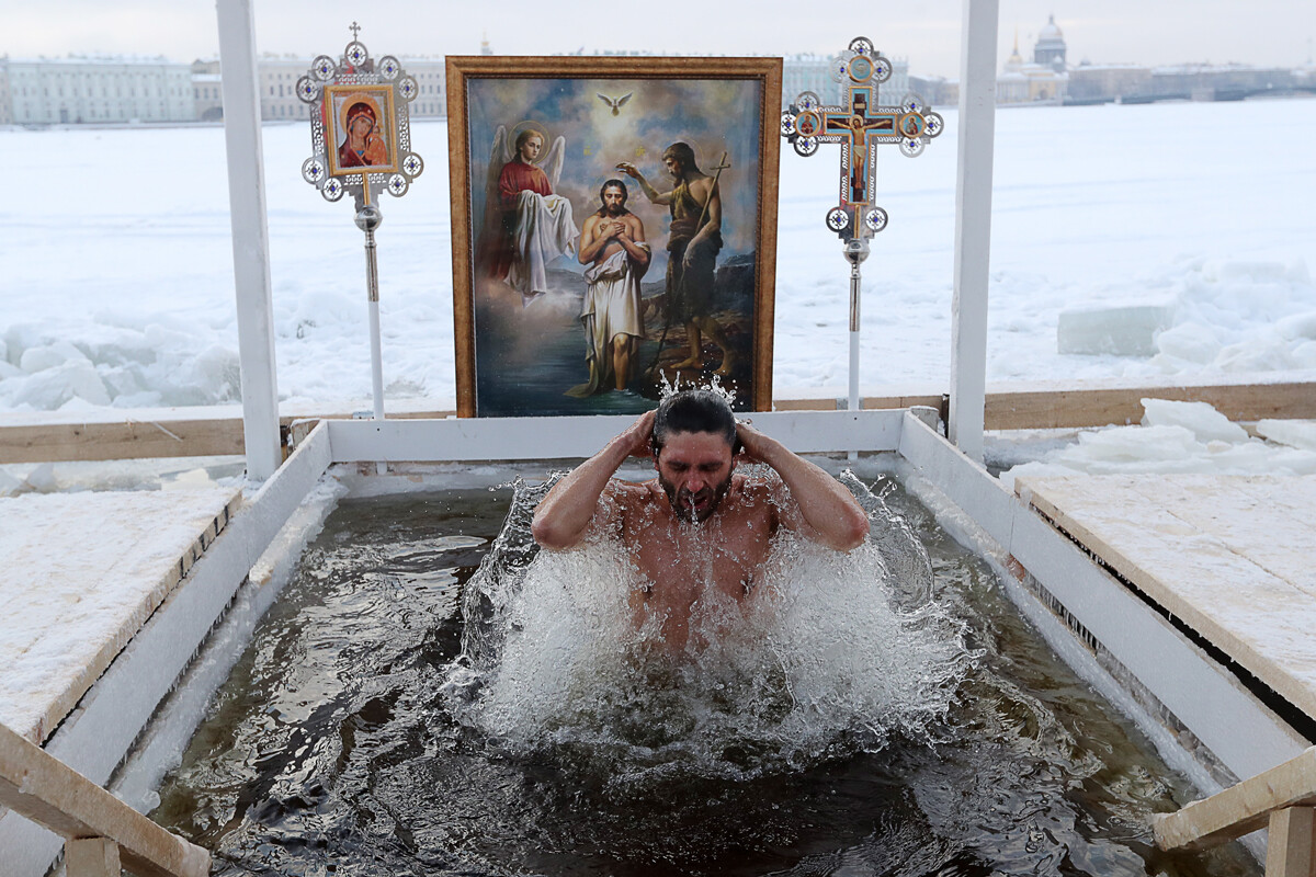 A man bathes in an ice-hole in Neva river in St. Petersburg, Russia