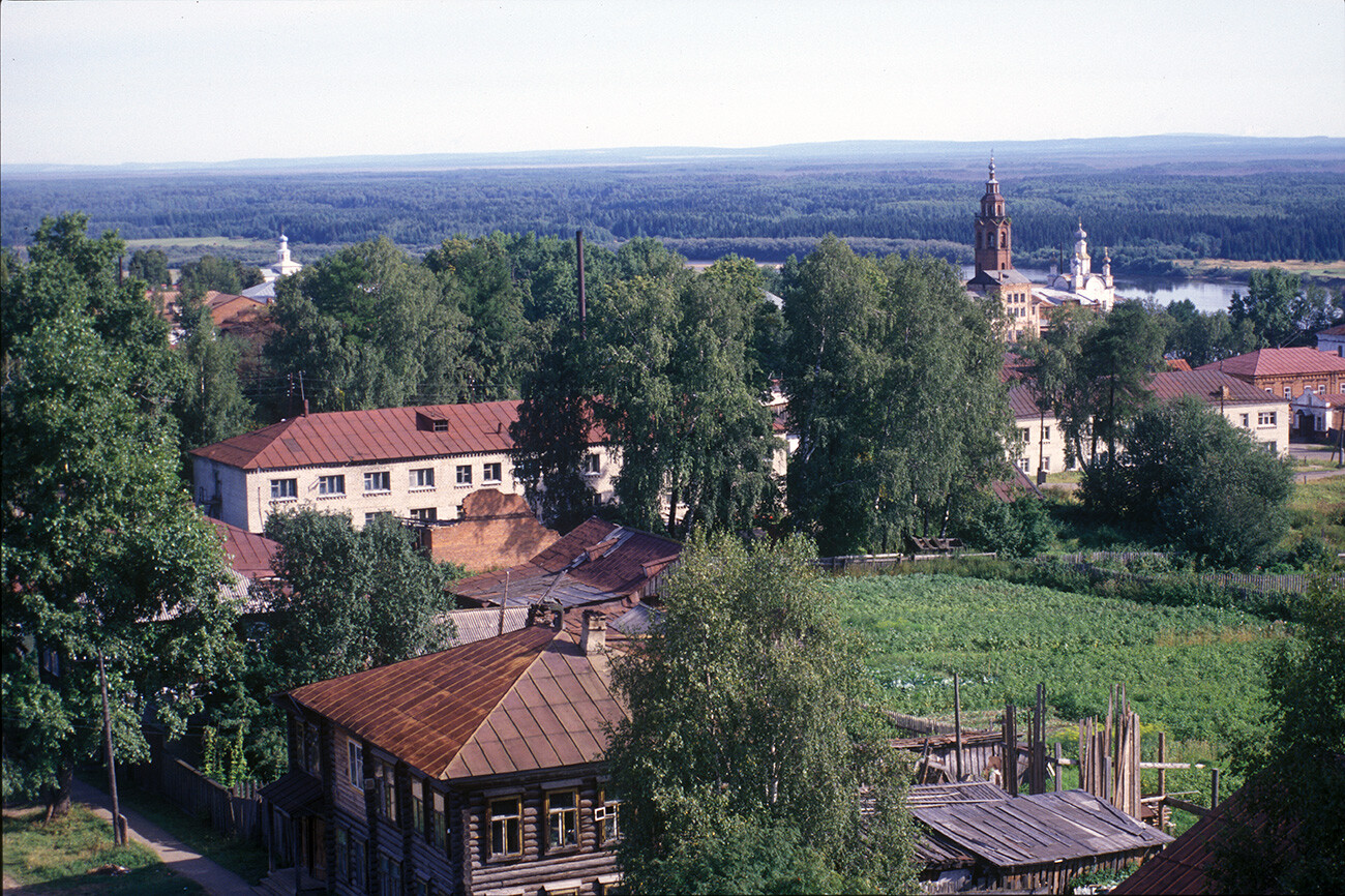 Cherdyn. View northeast from water tower. Churches from left: St. John the Divine; Transfiguration; bell tower & Resurrection Cathedral. Background: Kolva River. August 14, 2000
