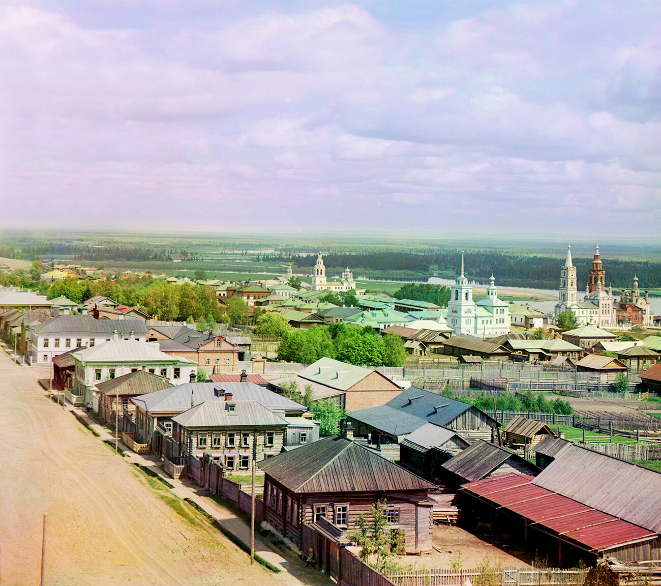 Cherdyn. View northeast from water tower. Churches from left: St. John the Divine; Epiphany; Dormition of the Virgin; Transfiguration; Resurrection Cathedral. Background: Kolva River. 1912