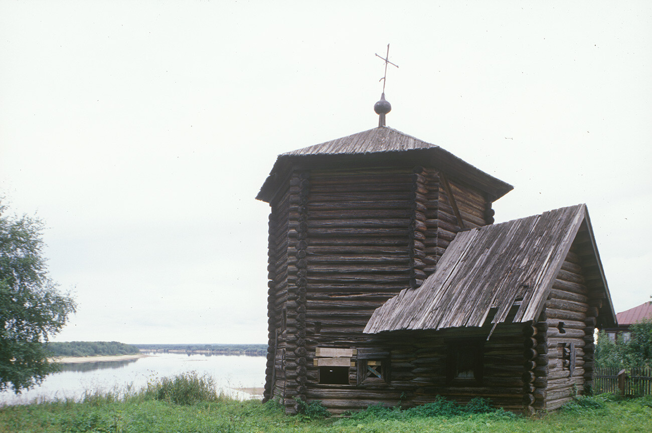 Pianteg. Log Church of the Epiphany, southeast view. Built perhaps in early 17th century; considered the oldest surviving wooden structure in the Urals. Background: Kama River. August 15, 2000