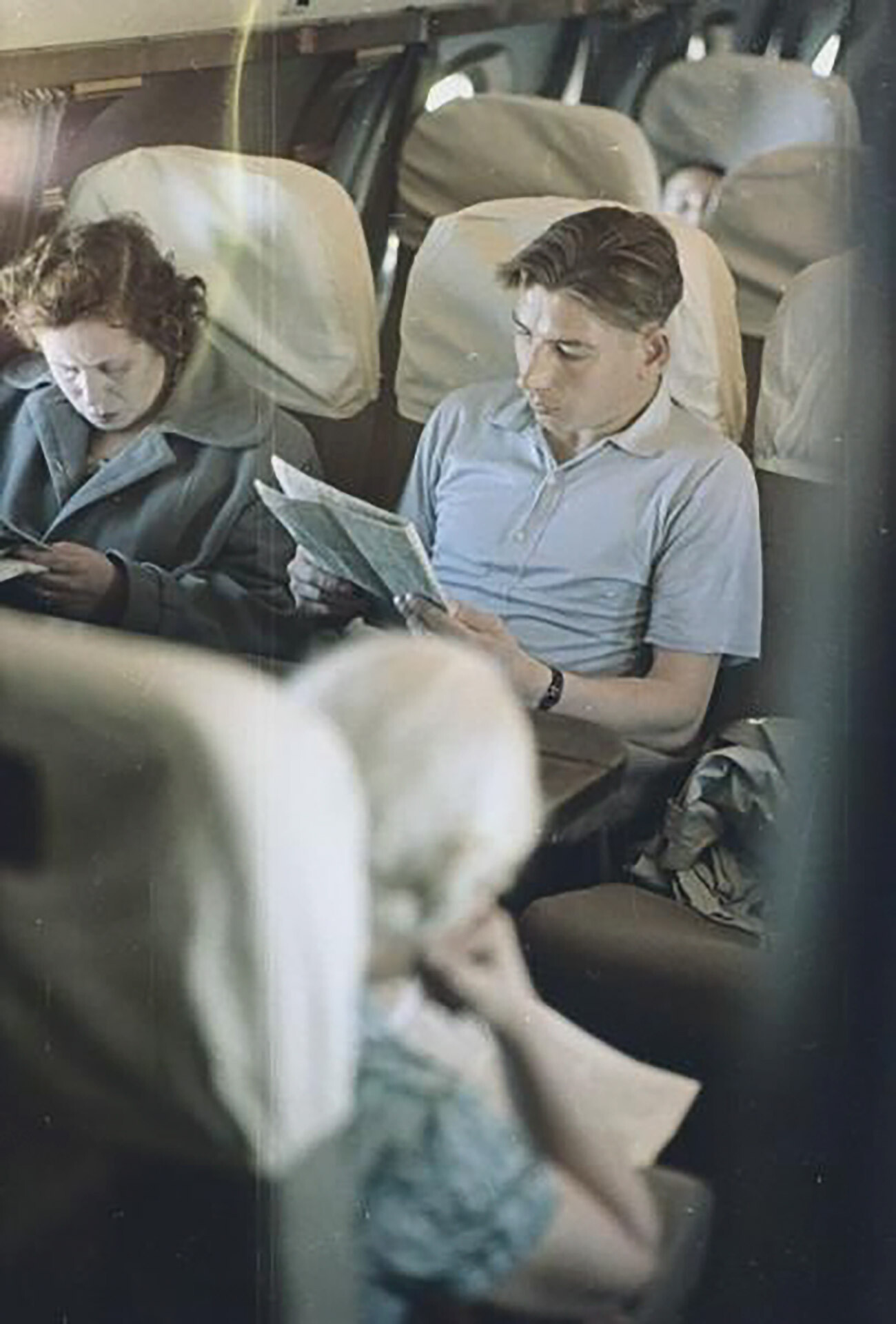 Passengers in an airplane cabin. 1960.