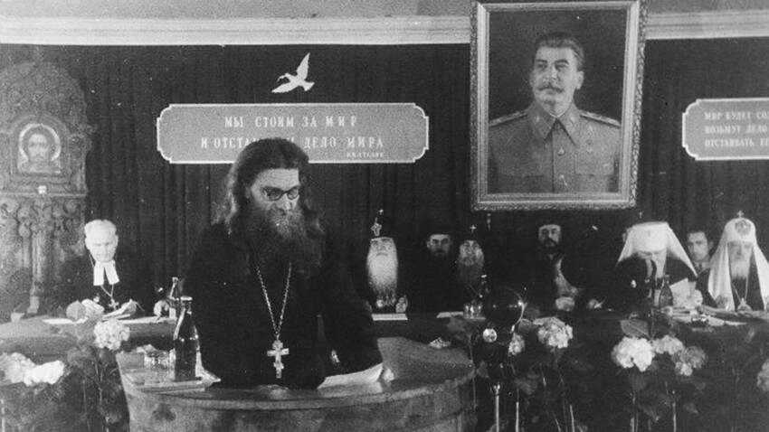 The clergy conducting their meeting under Stalin's' portrait, 1940s.