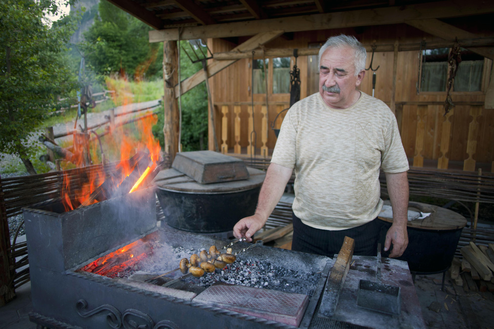 Preparing a "shashlik" (typical dish of the Caucasus cuisine) at the sunset