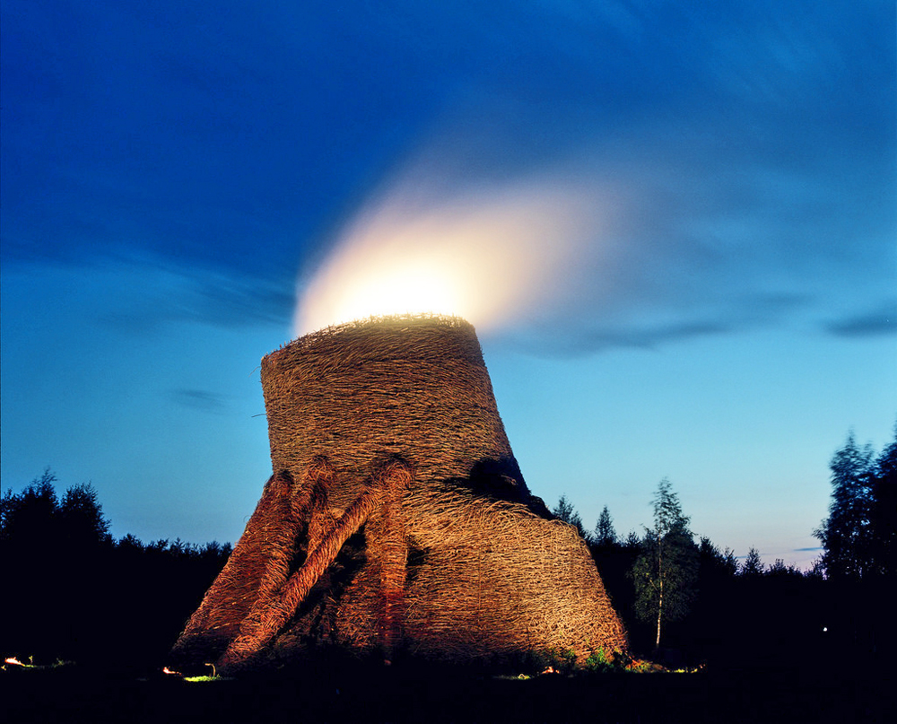 HYPERBOLIC COOLING TOWERThe artist has built a huge weaved tower of rods and twigs in Nikola-Lenlvets. It glows and gushes the smoke, but with no harm to ecology. It offers the audience a chance to see how the industry is getting absorbed by the environment.