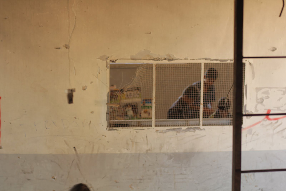 Children discovering the aftermath of their school in Azaz, north-western Syria.