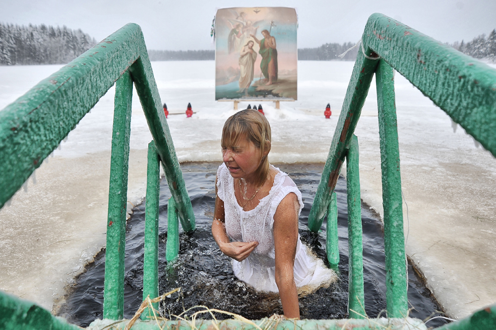 On the eve of the Epiphany, it is customary for Orthodox Christians to plunge into the frozen water. (Leningradskaya oblast, Russia)