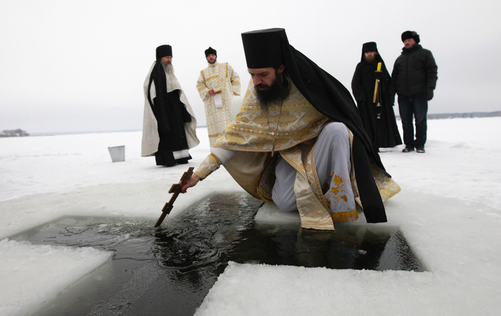 Priests and regular believers from many different churches go down to a lake or a river, where a hole has been cut into the ice in the shape of a cross. This opening in the ice is called a “jordan,” in honor of the holy River Jordan, in which Jesus was baptized. (Vologda region, Russia)