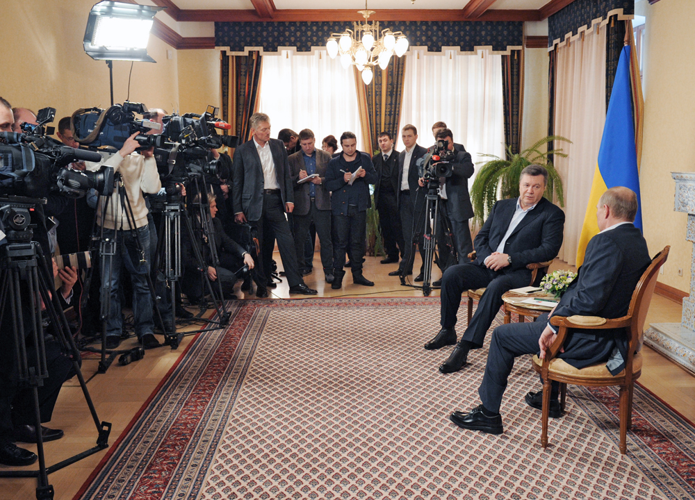 Russian President Vladimir Putin, foreground, right, with Ukrainian President Viktor Yanukovych, background, right, at Zavidovo residence.
