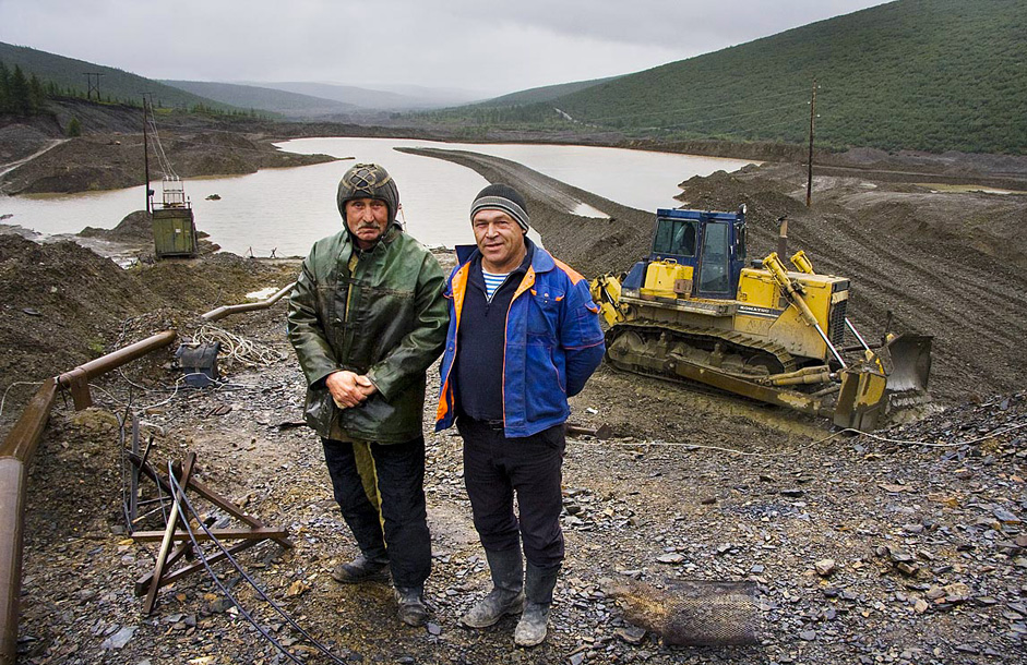 Kolyma is home to one of Russia's most abundant gold mining regions. On this picture we can see gold prospectors against the backdrop of a typical gold mine. Water is piped from a reservoir to flush the gold-bearing ores and separate the gold in a rinsing device.