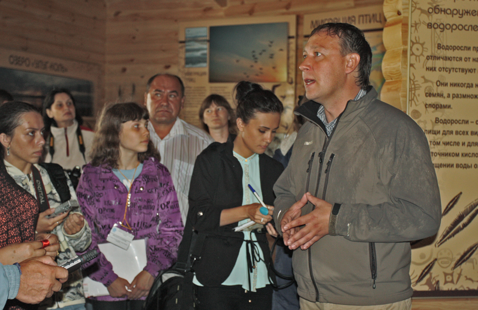 The director of Khakassia Reserve, Viktor Nepomnyaschy, officially opens the new visitor center. The occasion was attended by representatives of the Republic of khakassia, students, and reporters.