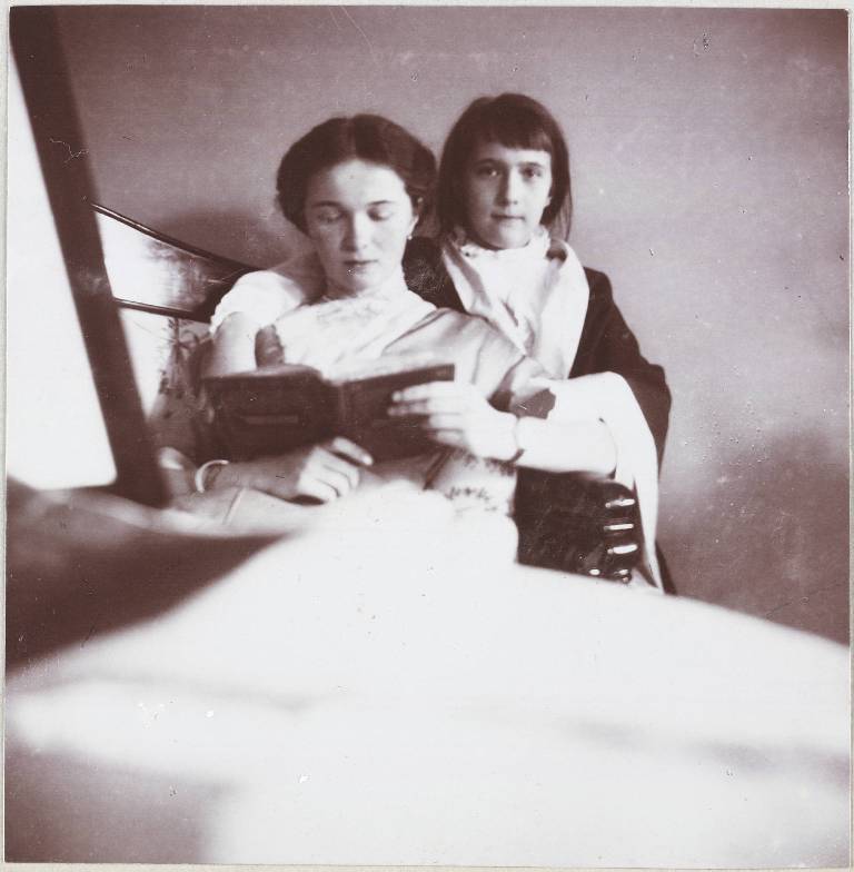 The children, four daughters and one son, were raised and educated together in the Imperial Palace. / Princess Olga (left) reads to Anastasia.