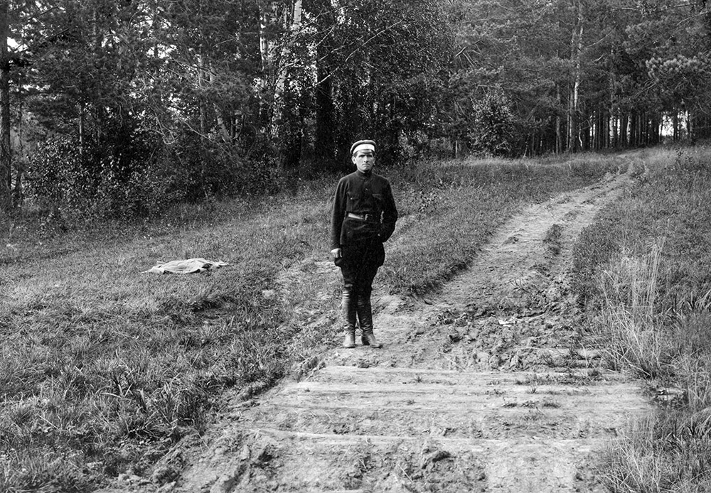 One of the regicides, revolutionary Peter Ermakov, on a small bridge over some sleepers in Porosenkov Ravine, where the bodies of the Imperial family and their servants were hidden. 1924. According to the guard Strekotin, Peter Ermakov finished off the dying members of the family with a bayonet.