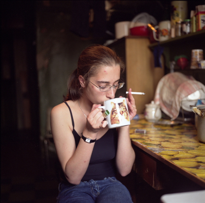 Karina, une étudiante en architecture, prend le thé dans la cuisine d'un voisin. Elle est née et a toujours vécu dans cet habitat communautaire du centre de Saint Petersburg. Elle y apprécie le sens de la communauté et n'envisage pas de déménager.
