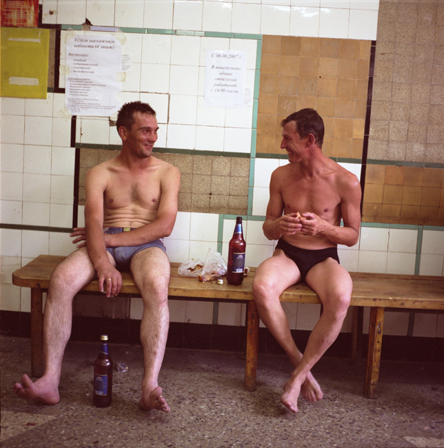 Men relaxing after having a bath in a public bath. There is still no hot water in many communal apartments, so people have to go to public baths to wash.