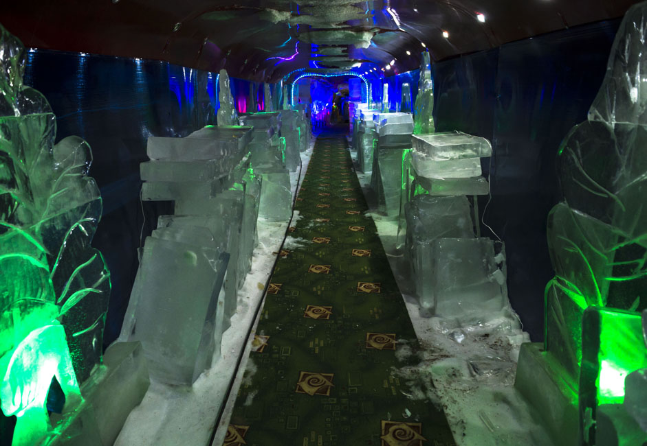 巨大な氷の洞窟には数多くの通路があり、色とりどりの照明に照らし出されている。