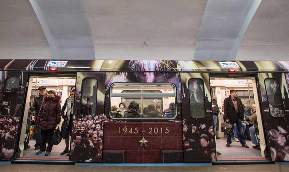 Passengers ride aboard a subway train decorated with World War II era posters during its first trip in Moscow, April 22, 2015. Russia will celebrate the Victory in WWII on May 9, 2015.