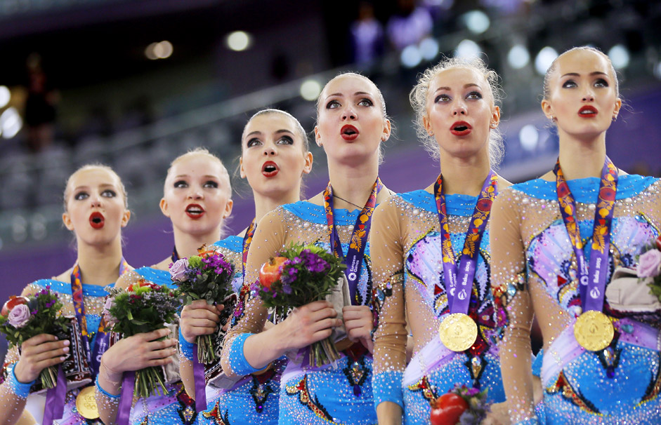 Members of the gold medalist team of Russia sing the national anthem during the medal ceremony at the Gymnastics Rhythmic Group All-Around Final event at the Baku 2015 European Games at the National Gymnastics Arena in Baku, Azerbaijan, 17 June 2015.