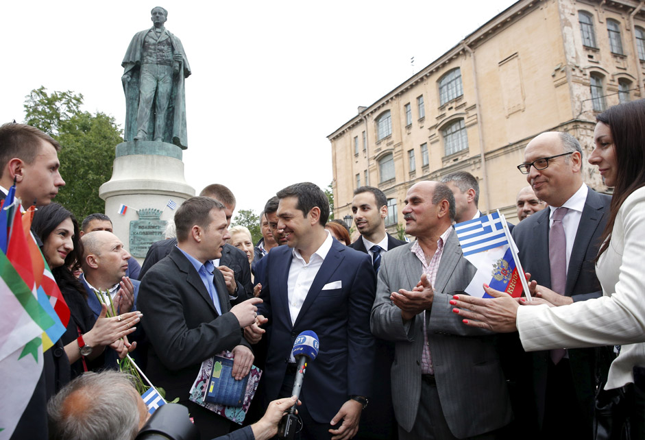 Greek Prime Minister Alexis Tsipras (C) speaks with Greek expatriates in frot of the statue of Russian-born founder of modern Greek state Ioannis Kapodistrias in St. Petersburg, Russia, June 19, 2015